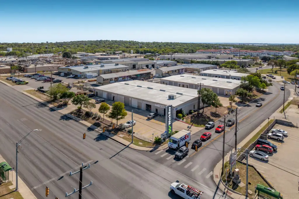 Aerial view of a warehouse for rent in San Antonio with multiple industrial units, parking, and street access.