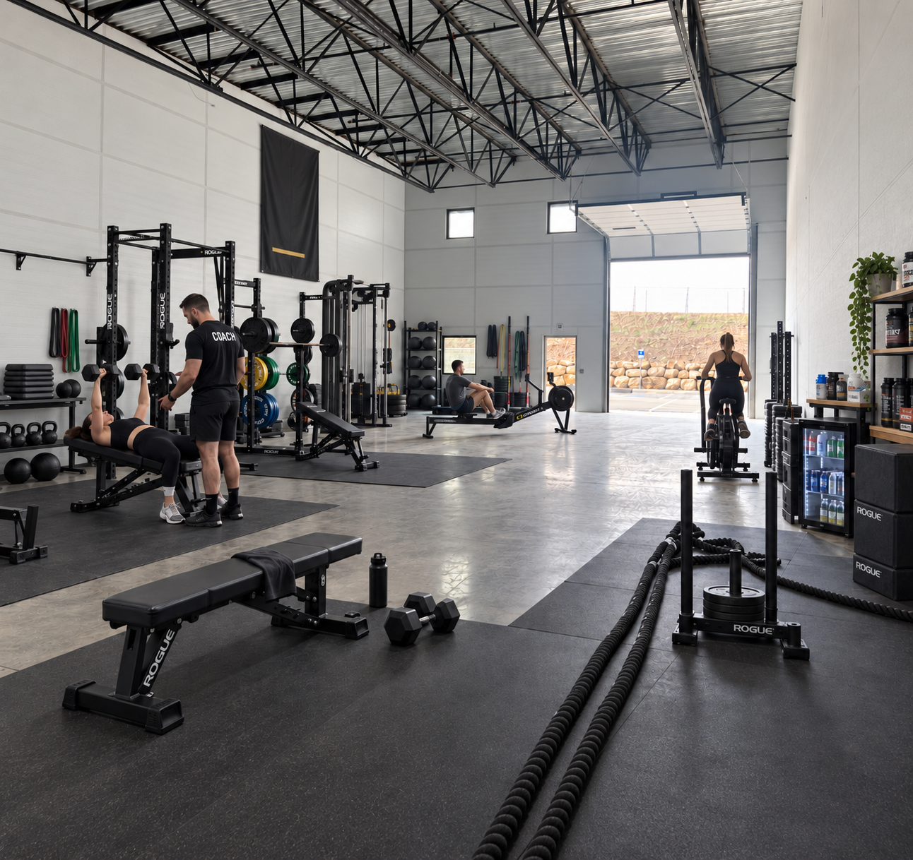 Trainer working with a client inside a private WorkBay wellness space